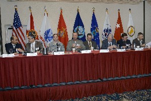 Panelists addressing conference attendees in January are (l-r) Capt. Carl Lee, Naval Air Warfare Center Training Systems Division; Joseph A. Giunta Jr., PEO STRI Acquisition Center; Col. Craig Langhauser, USA, Simulation and Training Technology Center; Co